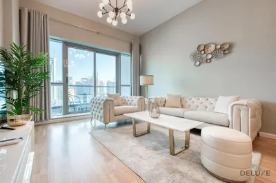 a living room with a couch and a table at Elegant 2BR at The Point Dubai Marina by Deluxe Holiday Homes in Dubai
