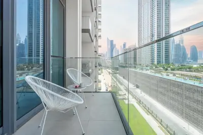 a balcony with two chairs and a view of a city at GuestReady - The Ivory Coast Downtown Views in Dubai