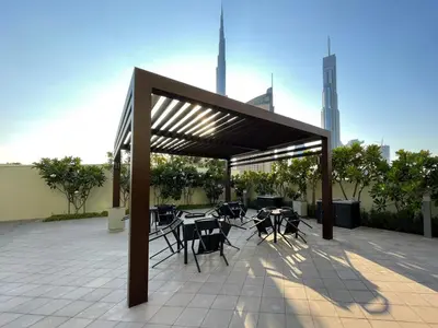 a pavilion with tables and chairs on a patio at GuestReady - The Ivory Coast Downtown Views in Dubai