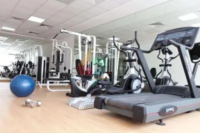 a gym with several exercise bikes and a treadmill at Luxury Escapes - 1BR with Balcony & Stunning Marina View - MVT in Dubai