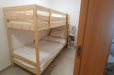 a room with two bunk beds in a room at Modern 1BR in Jumeirah Village Circle (Pool View) in Dubai