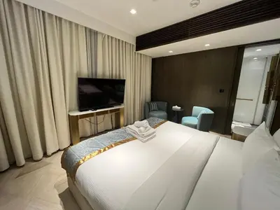 a hotel room with a large bed and a television at FIVE Palm Jumeirah - 2 Bedrooms & Maid Room Apartment in a Splendid Resort in Dubai