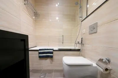 a bathroom with a toilet and a bath tub at Luxury Escapes - Quiet Studio near Expo City and DWC Airport - CELESTIA TOWER in Dubai