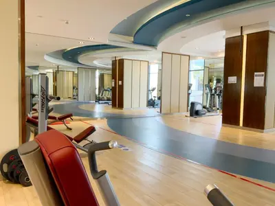 a gym with cardio equipment in a building at Luxury Escapes - Quiet Studio near Expo City and DWC Airport - CELESTIA TOWER in Dubai