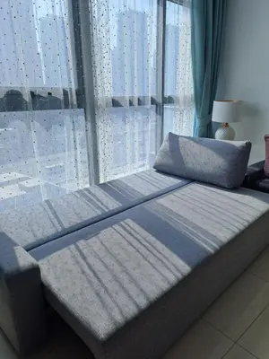 a bed in a room with a large window at Newly furnished One Bedroom Apartment next to Metro & Beach in Marina Residence in Dubai