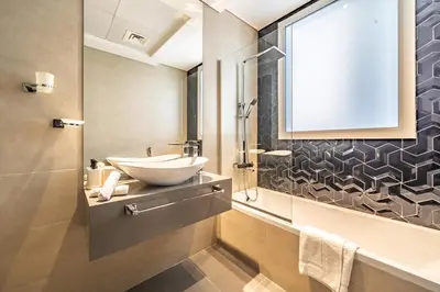a bathroom with a sink and a mirror at Stylish Waterfront Apartment With Views on Canal in Dubai