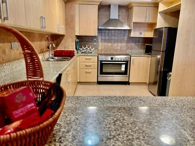 a kitchen with a counter top with a stove top oven at Luxury Apartment Palm Jumeirah in Dubai