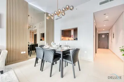 a dining room with a black table and chairs at Elegant 2BR at Downtown Views Downtown Dubai by Deluxe Holiday Homes in Dubai