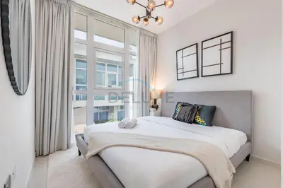 a bedroom with a large bed and a window at Furnished 3-Bedroom Townhouse, Just Minutes Drive from Al Marmoom Heritage Village and Popular Dubai Attractions, Albizia, Damac Hills 2 by Deluxe Holiday Homes in Dubai