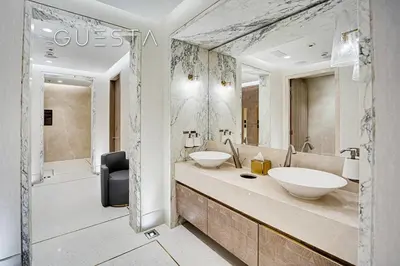 a bathroom with two sinks and a large mirror at The Palm Tower, Nakheel Mall, Palm Jumeirah in Dubai