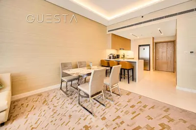 a dining room with a table and chairs at The Palm Tower, Nakheel Mall, Palm Jumeirah in Dubai