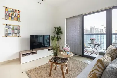 a living room with a couch and a tv at Frank Porter - Time Place in Dubai