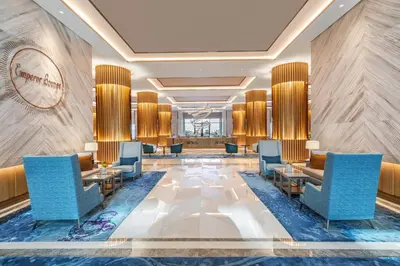 a lobby of a hotel with chairs and tables at Taj Exotica Resort & Spa, The Palm, Dubai in Dubai
