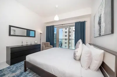 a bedroom with a large bed and a window at Stunning 1BR with Partial Sea View in Damac Heights, Dubai Marina-21AB03 in Dubai