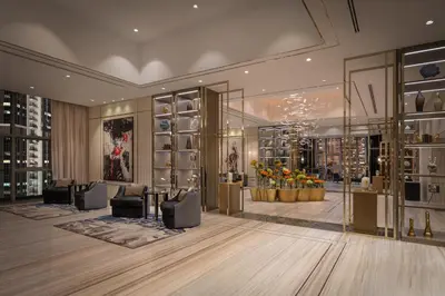 a lobby with a shoe store with couches and flowers at Paramount Hotel Midtown in Dubai