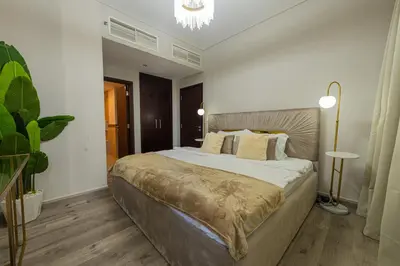 a bedroom with a large bed and a plant at Luxury 2BR Burj Khalifa Fountain View with Pool, Gym, and Near Dubai Mall in Dubai