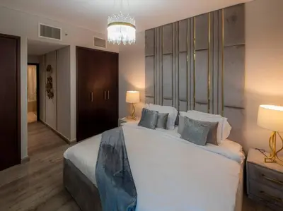 a bedroom with a large bed with a chandelier at Luxury 2BR Burj Khalifa Fountain View with Pool, Gym, and Near Dubai Mall in Dubai
