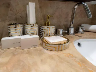 a bathroom counter with towels and baskets on a sink at Luxury 2BR Burj Khalifa Fountain View with Pool, Gym, and Near Dubai Mall in Dubai