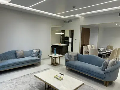 a living room with two blue couches and a table at USMANS 4BDRM JBR Sadaf Next to Ritz Carlton Walk Daily Housekeeping JBR in Dubai
