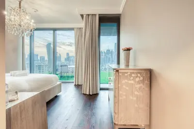 a bedroom with a bed and a large window at Luxurious 3 Bedroom Apartment in Boulevard Point, Connected to Dubai Mall in Dubai