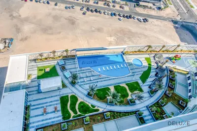 an overhead view of a resort with a beach at Whimsical 2BR at Bella Rose Barsha South by Deluxe Holiday Homes in Dubai