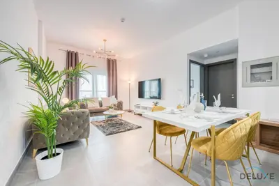 a living room with a white table and chairs at Whimsical 2BR at Bella Rose Barsha South by Deluxe Holiday Homes in Dubai
