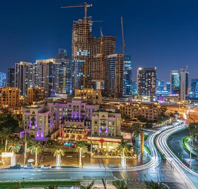 a city skyline at night with buildings and roads at Walk to Burj Khalifa from this 2BR with Skyline Balcony View in Dubai
