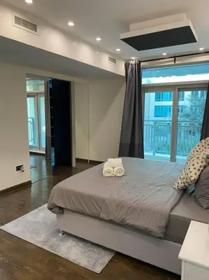 a bedroom with a bed with two towels on it at Luxury 2BR Walk to Burj Khalifa and Dubai Mall with Pool and Gym in Dubai