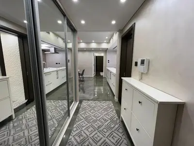 a large bathroom with white cabinets and a mirror at Luxury 2BR Walk to Burj Khalifa and Dubai Mall with Pool and Gym in Dubai