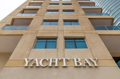 a sign on the front of a katight bay building at Frank Porter - Yacht Bay in Dubai