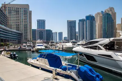 a group of boats docked at a marina in a city at Frank Porter - Yacht Bay in Dubai