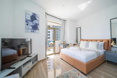a bedroom with a large bed and a flat screen tv at Frank Porter - Yacht Bay in Dubai