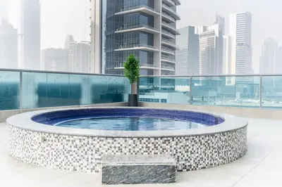 a hot tub on the roof of a building at GuestReady Holiday Homes - On The Rocks in Dubai