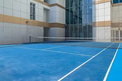 a tennis court in front of a building at Frank Porter - Mon Reve in Dubai