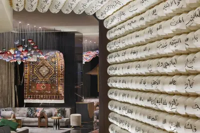 a wall filled with white plates with writing on it at W Dubai - Mina Seyahi in Dubai