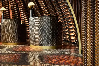 a row of metal vases in a wine cellar at W Dubai - Mina Seyahi in Dubai