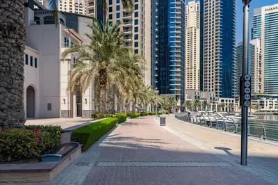 a city street with palm trees and tall buildings at Frank Porter - The Point in Dubai