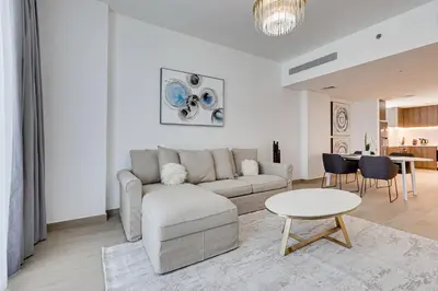 a living room with a couch and a table at Lovely sea view apt La Cote 1 La Mer 1min to beach in Dubai