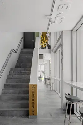a stairwell in a building with a staircase with a sign at Emirates Sports Hotel, Dubai Sports City in Dubai
