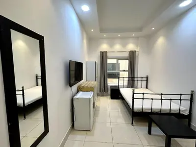 a room with two bunk beds and a mirror at Economical Rooms for rent in Dubai in Dubai