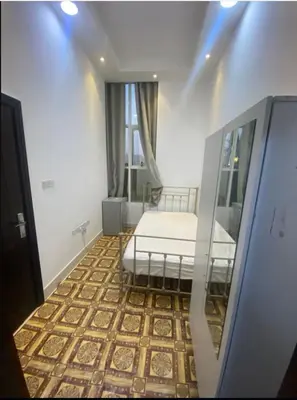 a room with a bed in a room with a window at Economical Rooms for rent in Dubai in Dubai
