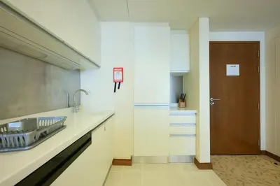 a kitchen with a sink and a door in it at Emaar Fashion Avenue - Formerly Address Dubai Mall Four Apple in Dubai
