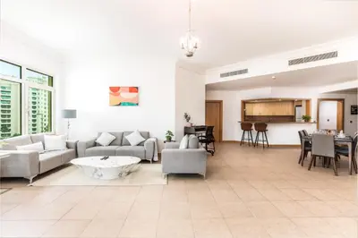 a living room with a couch and a table at Dreamy and Spacious 3BR Unique Palm Jumeirah in Dubai