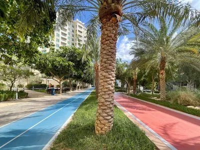 a palm tree in the middle of a street at Dreamy and Spacious 3BR Unique Palm Jumeirah in Dubai