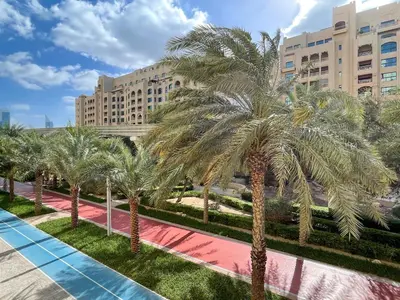a row of palm trees in front of a building at Dreamy and Spacious 3BR Unique Palm Jumeirah in Dubai