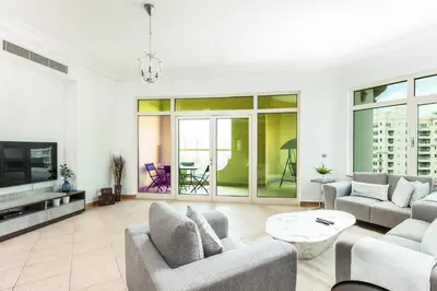 a living room with two couches and a tv at Dreamy and Spacious 3BR Unique Palm Jumeirah in Dubai