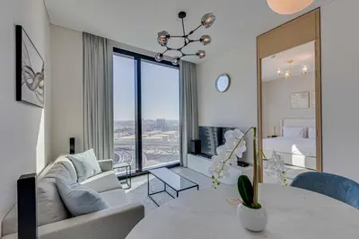 a living room with a couch and a table at Stylish 1BD apartment in Address Beach Residence in Dubai