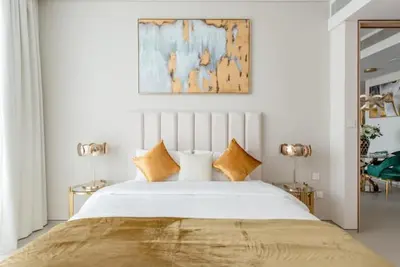 a bedroom with a large white bed with two lamps at 2 BDR Apt The Address Beach Resort JBR in Dubai