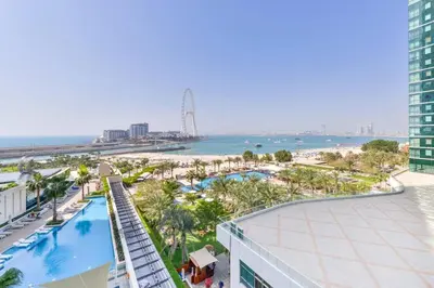 an aerial view of a resort with a pool and the beach at 2 BDR Apt The Address Beach Resort JBR in Dubai