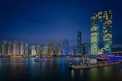 a view of a large city at night at 2 BDR Apt The Address Beach Resort JBR in Dubai
